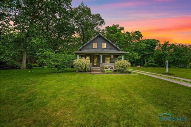 2617 Shetland Rd, Toledo, OH 43617 - view of front of home with a porch, a lawn, and view of wooded area