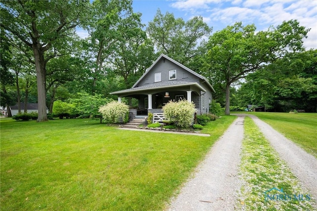 2617 Shetland Rd, Toledo, OH 43617 - bungalow-style home with driveway, a porch, a front yard, and view of scattered trees
