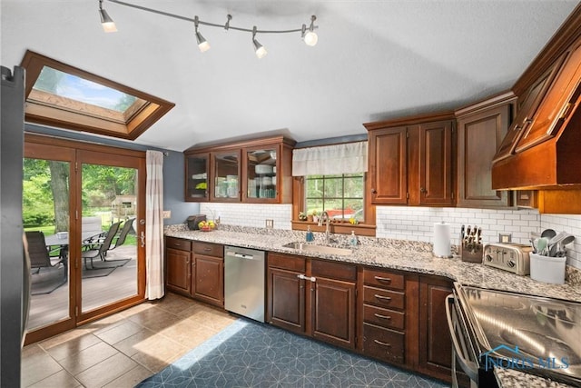 2617 Shetland Rd, Toledo, OH 43617 - kitchen featuring stainless steel dishwasher, plenty of natural light, tasteful backsplash, range with electric stovetop, and lofted ceiling