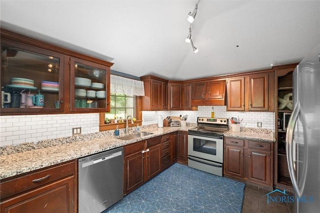 2617 Shetland Rd, Toledo, OH 43617 - kitchen with stainless steel appliances, custom range hood, backsplash, light stone counters, and vaulted ceiling