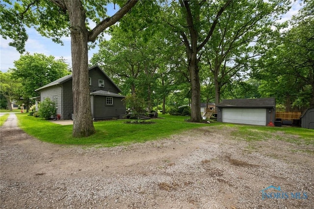2617 Shetland Rd, Toledo, OH 43617 - view of green lawn featuring an outbuilding and a garage