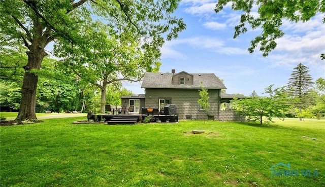 2617 Shetland Rd, Toledo, OH 43617 - rear view of property featuring a deck, a lawn, and a chimney