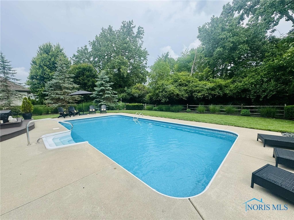 7458 Kaolin Rd, Maumee, OH 43537 - swimming pool with a patio area and view of scattered trees
