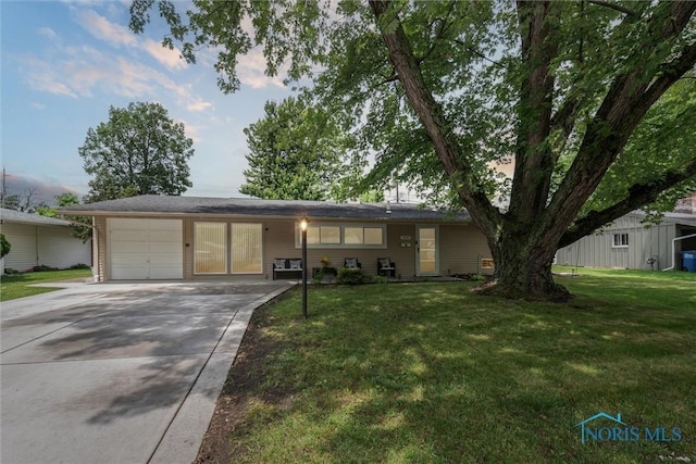 3530 Devon Hill Rd, Toledo, OH 43606 - ranch-style home featuring a garage, concrete driveway, and a front yard