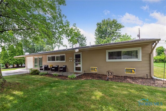 3530 Devon Hill Rd, Toledo, OH 43606 - ranch-style home with a front yard, concrete driveway, an outdoor hangout area, and a patio