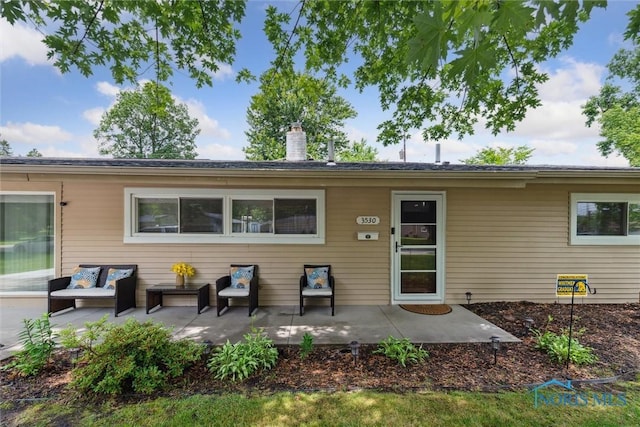 3530 Devon Hill Rd, Toledo, OH 43606 - back of property with a patio area, an outdoor hangout area, and a chimney