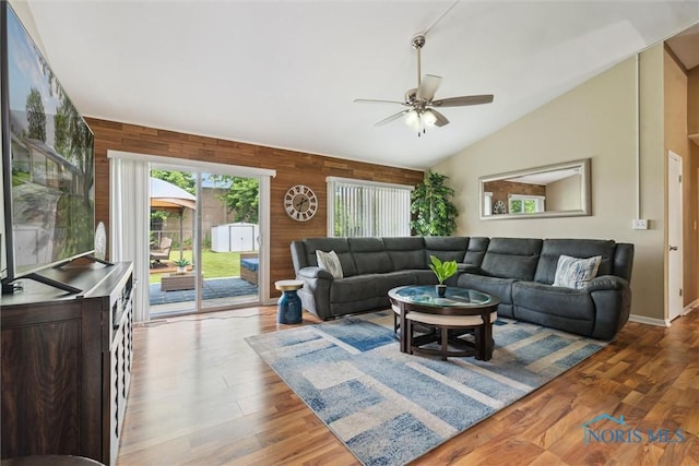 3530 Devon Hill Rd, Toledo, OH 43606 - living room with ceiling fan, vaulted ceiling, wooden walls, and wood finished floors