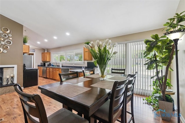 3530 Devon Hill Rd, Toledo, OH 43606 - dining space with light wood-type flooring, vaulted ceiling, and recessed lighting