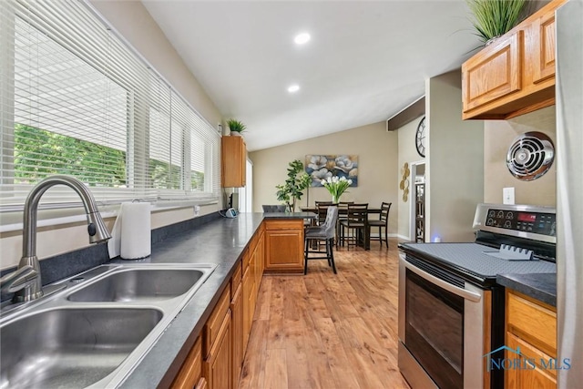 3530 Devon Hill Rd, Toledo, OH 43606 - kitchen featuring stainless steel electric range oven, light wood-type flooring, lofted ceiling, dark countertops, and recessed lighting