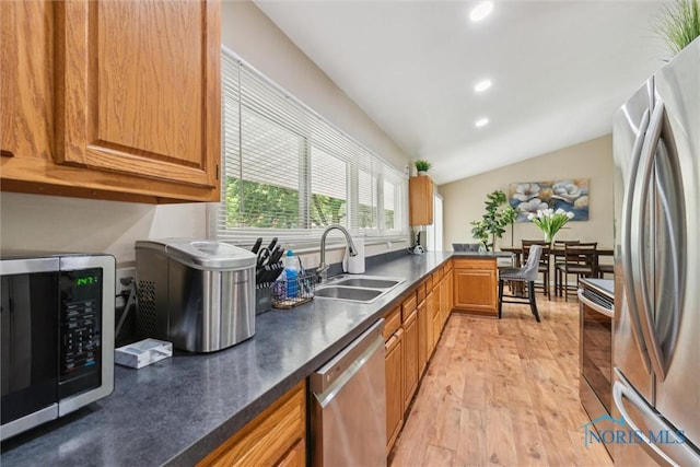 3530 Devon Hill Rd, Toledo, OH 43606 - kitchen featuring appliances with stainless steel finishes, dark countertops, recessed lighting, vaulted ceiling, and light wood finished floors