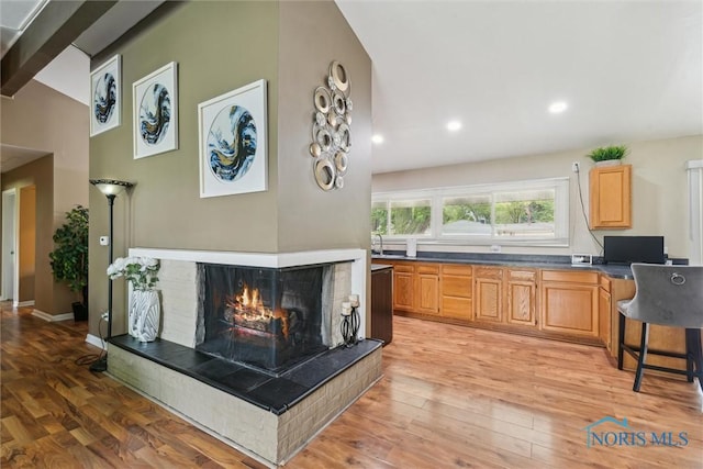 3530 Devon Hill Rd, Toledo, OH 43606 - living area featuring light wood-style flooring, a multi sided fireplace, a desk, and recessed lighting