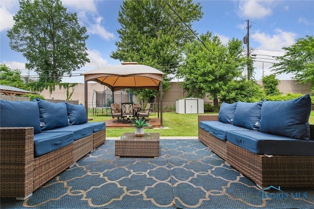 3530 Devon Hill Rd, Toledo, OH 43606 - view of patio / terrace featuring an outdoor living space, a storage unit, a trampoline, and a gazebo