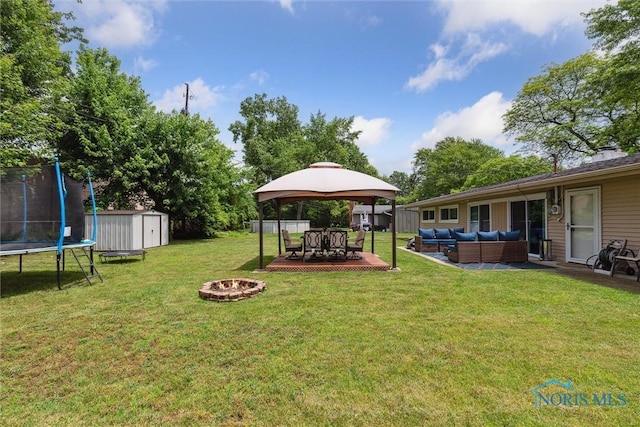 3530 Devon Hill Rd, Toledo, OH 43606 - view of grassy yard featuring a gazebo, an outdoor living space with a fire pit, a trampoline, a shed, and a patio area