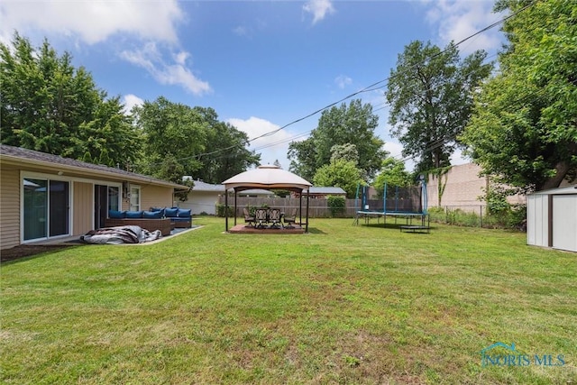 3530 Devon Hill Rd, Toledo, OH 43606 - fenced backyard with a trampoline, a gazebo, an outdoor living space, a storage unit, and a patio