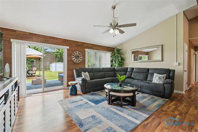 3530 Devon Hill Rd, Toledo, OH 43606 - living area with wooden walls, ceiling fan, vaulted ceiling, and wood finished floors