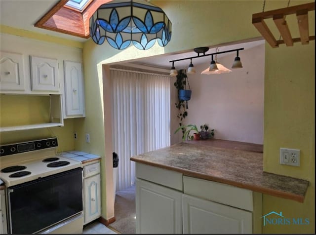 4745 Ottawa Trail Dr, Toledo, OH 43611 - kitchen featuring electric range, a skylight, and white cabinetry