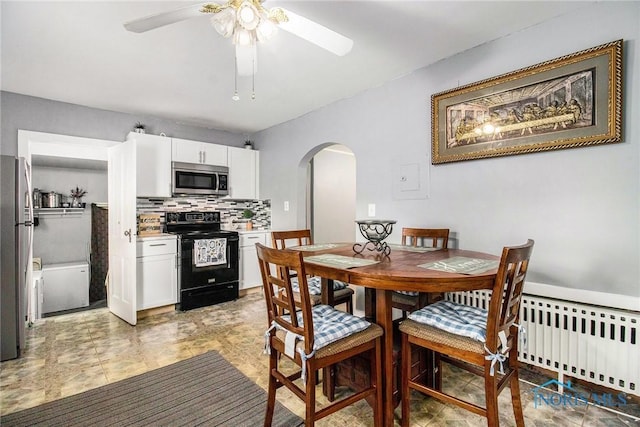 130 S 1st St, Hamler, OH 43524 - dining room with arched walkways, ceiling fan, and radiator heating unit