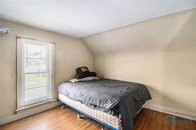 130 S 1st St, Hamler, OH 43524 - bedroom featuring wood finished floors and lofted ceiling
