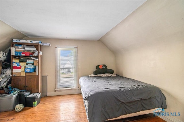 130 S 1st St, Hamler, OH 43524 - bedroom featuring vaulted ceiling and wood finished floors