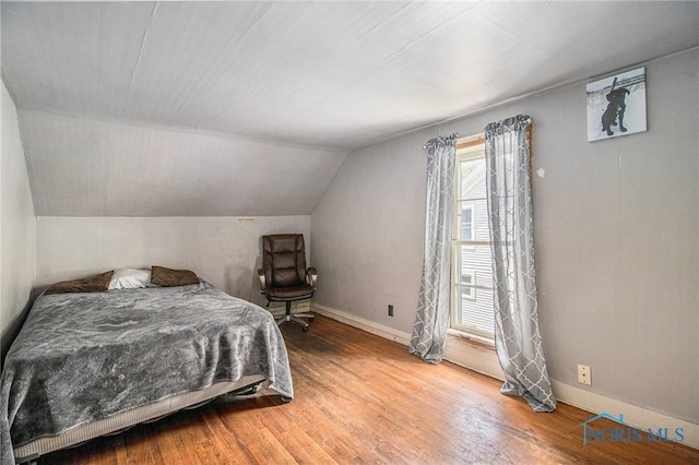 130 S 1st St, Hamler, OH 43524 - bedroom with wood finished floors and vaulted ceiling