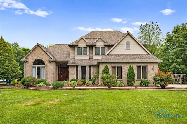 14285 Cuckle Creek Rd, Bowling Green, OH 43402 - view of front of property with brick siding, a shingled roof, and a front yard