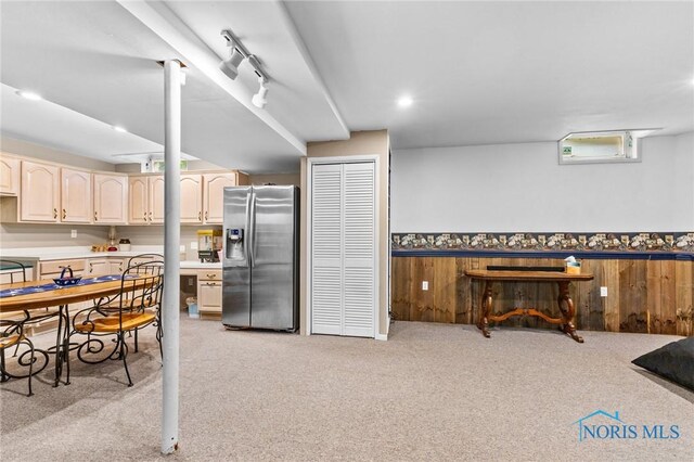 14285 Cuckle Creek Rd, Bowling Green, OH 43402 - kitchen with stainless steel fridge, light colored carpet, a wainscoted wall, light countertops, and wood walls