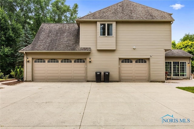 14285 Cuckle Creek Rd, Bowling Green, OH 43402 - view of side of home with driveway, roof with shingles, and a garage