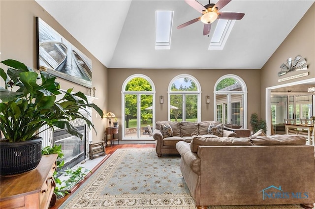 14285 Cuckle Creek Rd, Bowling Green, OH 43402 - living room featuring high vaulted ceiling, a skylight, ceiling fan, and wood finished floors