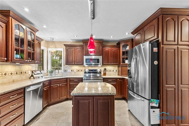 14285 Cuckle Creek Rd, Bowling Green, OH 43402 - kitchen with appliances with stainless steel finishes, hanging light fixtures, decorative backsplash, light tile patterned flooring, and recessed lighting