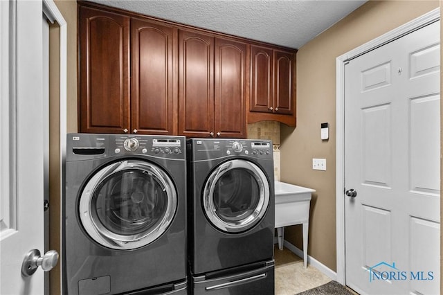 14285 Cuckle Creek Rd, Bowling Green, OH 43402 - laundry room with cabinet space, washer and clothes dryer, and a textured ceiling