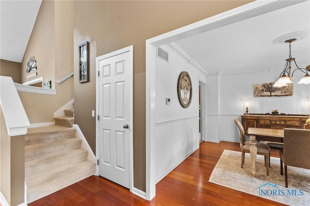 14285 Cuckle Creek Rd, Bowling Green, OH 43402 - entryway with wood finished floors, stairway, a chandelier, and crown molding