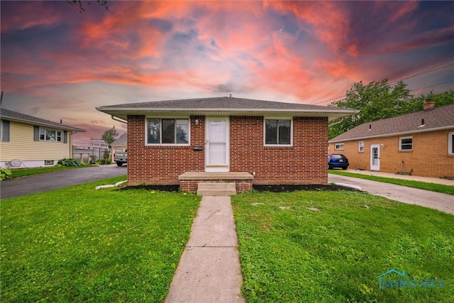 3431 146th St, Toledo, OH 43611 - bungalow-style house featuring a yard, brick siding, and roof with shingles