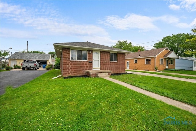 3431 146th St, Toledo, OH 43611 - bungalow-style home featuring brick siding, a front lawn, and asphalt driveway