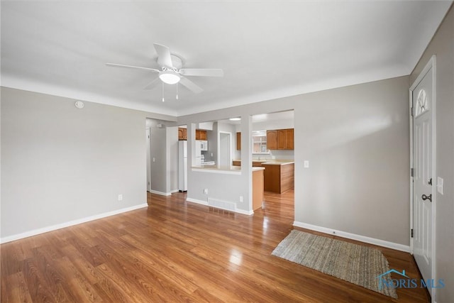 3431 146th St, Toledo, OH 43611 - unfurnished living room with ceiling fan and light wood-style floors