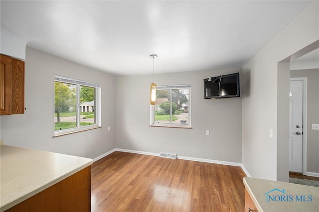 3431 146th St, Toledo, OH 43611 - unfurnished dining area featuring light wood-style floors and baseboards