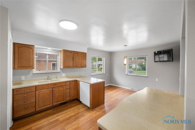 3431 146th St, Toledo, OH 43611 - kitchen featuring white dishwasher, a peninsula, light wood finished floors, and light countertops