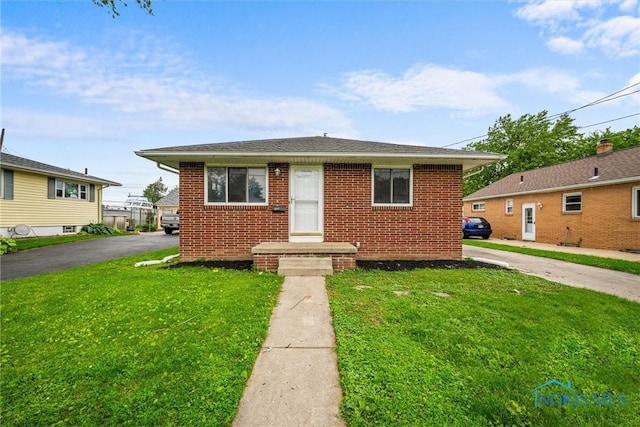 3431 146th St, Toledo, OH 43611 - bungalow featuring a front yard and brick siding