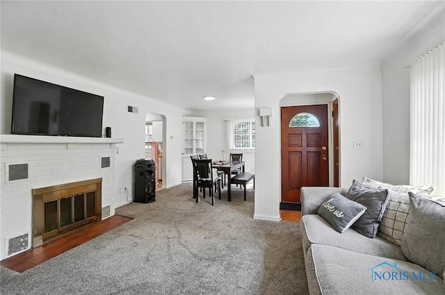 1732 Gilbert Rd, Toledo, OH 43614 - carpeted living area featuring arched walkways, a brick fireplace, and recessed lighting