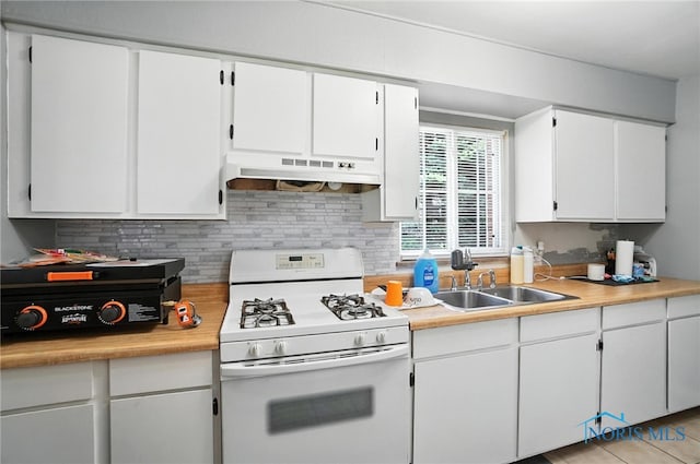 1732 Gilbert Rd, Toledo, OH 43614 - kitchen with white gas range, under cabinet range hood, backsplash, and light countertops