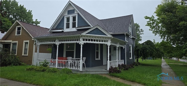 234 W Dudley St, Maumee, OH 43537 - view of front facade featuring a porch, a front lawn, and roof with shingles