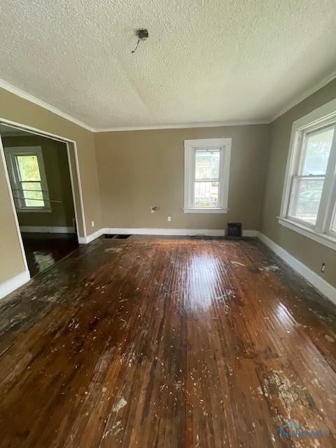 2024 Elliott Ave, Toledo, OH 43606 - spare room featuring wood-type flooring, ornamental molding, and a textured ceiling