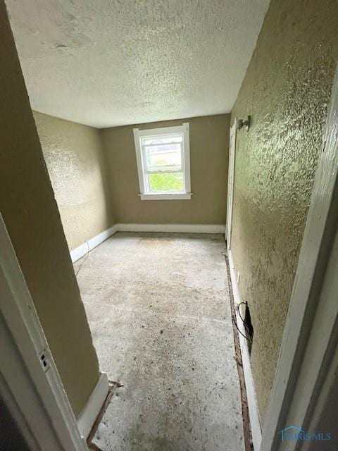 2024 Elliott Ave, Toledo, OH 43606 - unfurnished room featuring a textured ceiling and a textured wall
