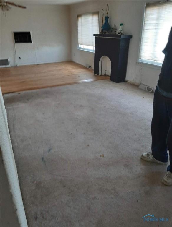 1708 Fredonia Ave, Toledo, OH 43608 - unfurnished living room with healthy amount of natural light and carpet flooring