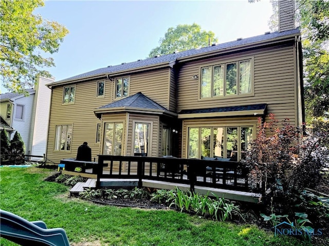 2456 Wembley Ter, Toledo, OH 43617 - back of property featuring a deck, a yard, and a chimney