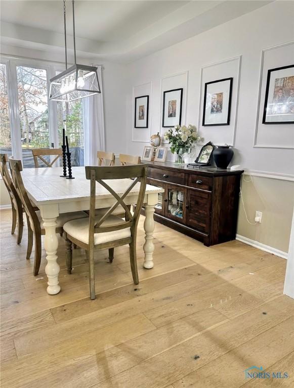 2456 Wembley Ter, Toledo, OH 43617 - dining room with a chandelier and light wood-style flooring