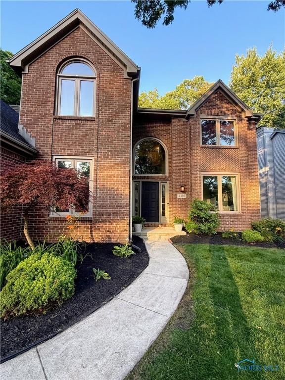 2456 Wembley Ter, Toledo, OH 43617 - traditional-style house featuring brick siding and a front lawn