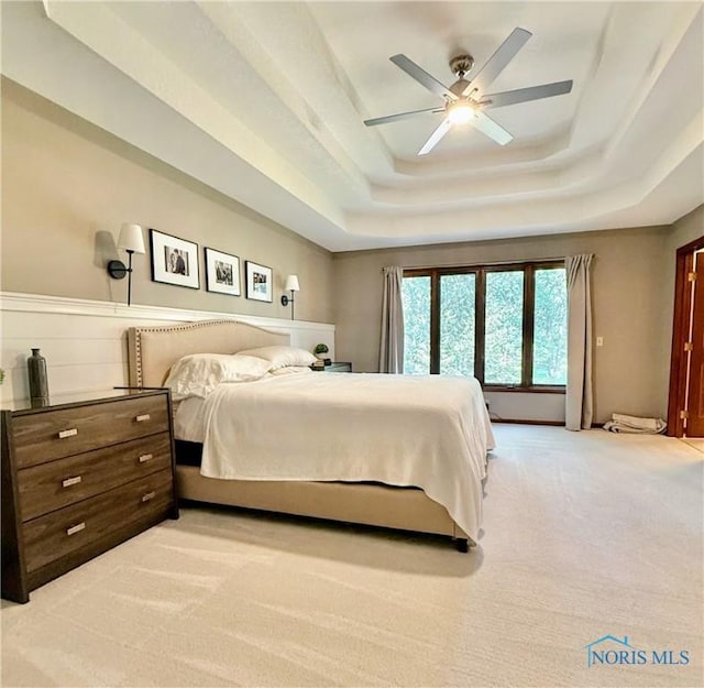 2456 Wembley Ter, Toledo, OH 43617 - bedroom featuring a raised ceiling, light colored carpet, and a ceiling fan