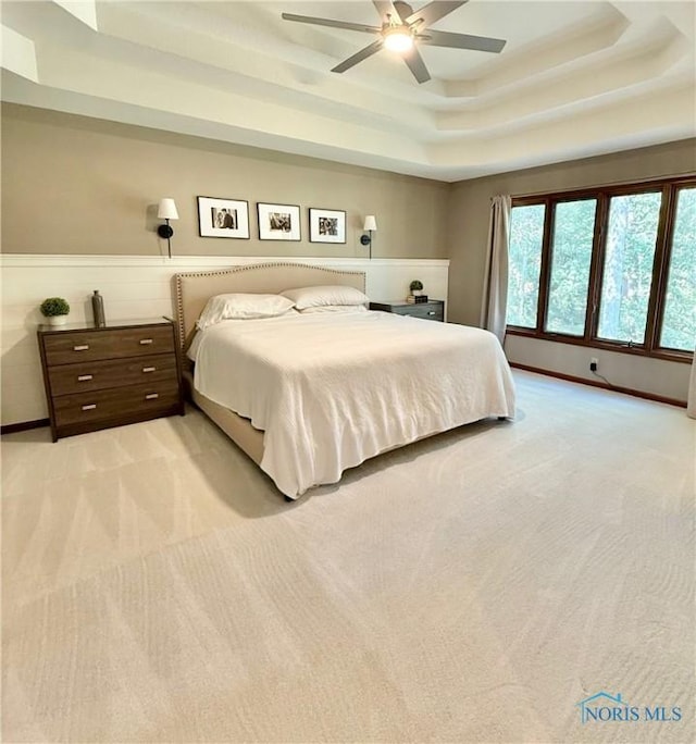 2456 Wembley Ter, Toledo, OH 43617 - bedroom with a raised ceiling, light colored carpet, and a ceiling fan