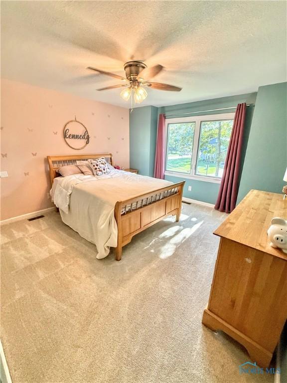 2456 Wembley Ter, Toledo, OH 43617 - bedroom featuring light colored carpet, a textured ceiling, and ceiling fan