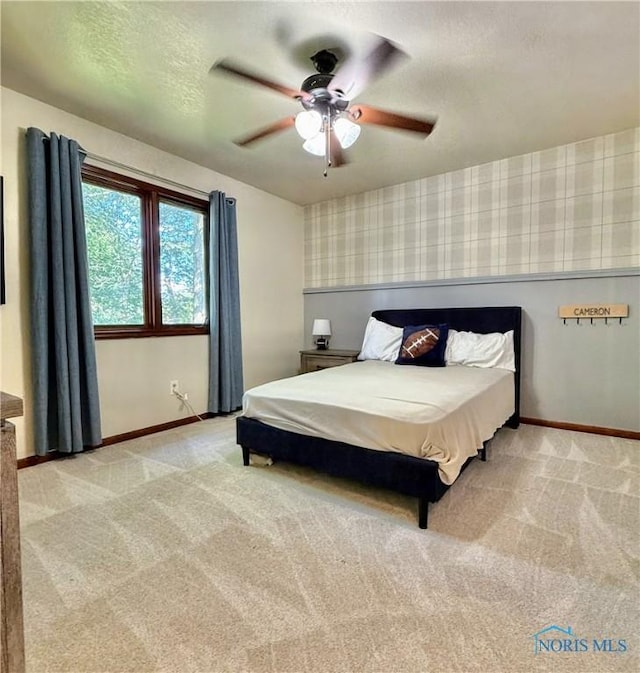 2456 Wembley Ter, Toledo, OH 43617 - bedroom featuring wallpapered walls, light colored carpet, ceiling fan, and a textured ceiling